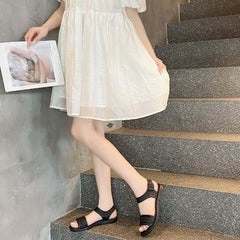 Huitich fashion sandals for women sizes 40 41 in black on model wearing white dress on stairs