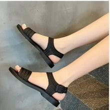 Huitich black sandals on feet, braided strap upper with open toe and ankle strap
