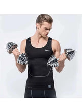 Man holding adjustable dumbbells with stacked chrome weight plates in a black tank top