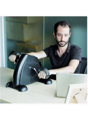 Huitich exercise bike pedal used as compact fitness equipment for legs and arms by a man at a desk