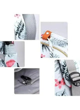 Light gray floral print baby travel bag detail showing interior mesh pocket and zipper pull
