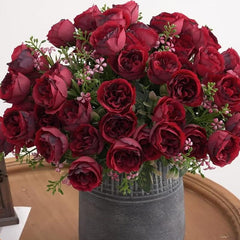 Huitich artificial mini peony bouquet with deep red blooms and green foliage in a decorative gray vase