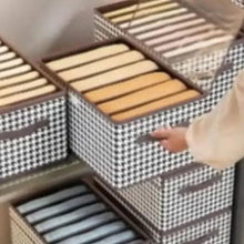 Foldable storage box with open lid, houndstooth fabric and striped dividers