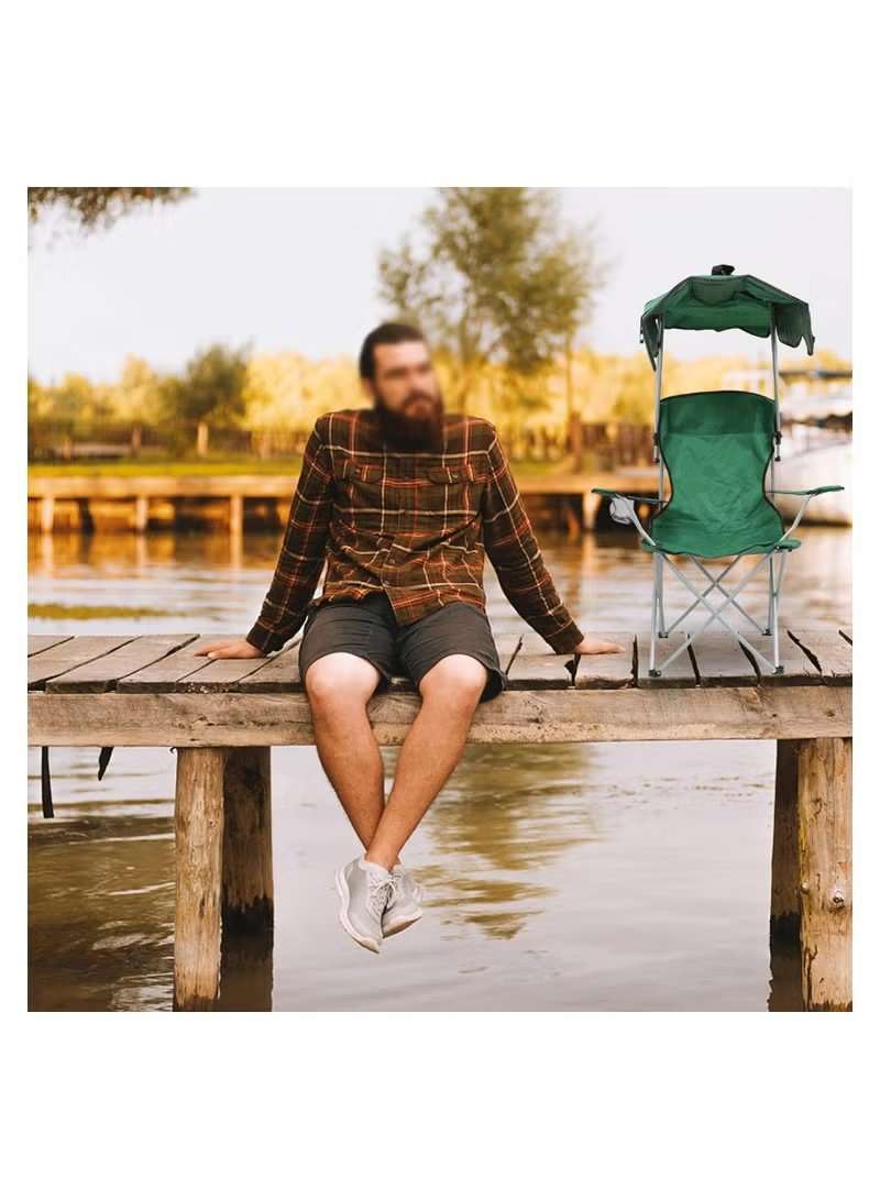 Huitich folding beach chair with canopy in green placed on wooden dock by a lake next to man sitting