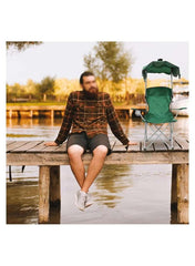 Huitich folding beach chair with canopy in green placed on wooden dock by a lake next to man sitting