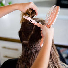 Huitich hair sectioning clips 10 pack used to section brown hair during styling with a peach brush