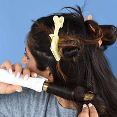 Huitich hair sectioning clips 10 pack holding hair in place while curling with a white curling iron
