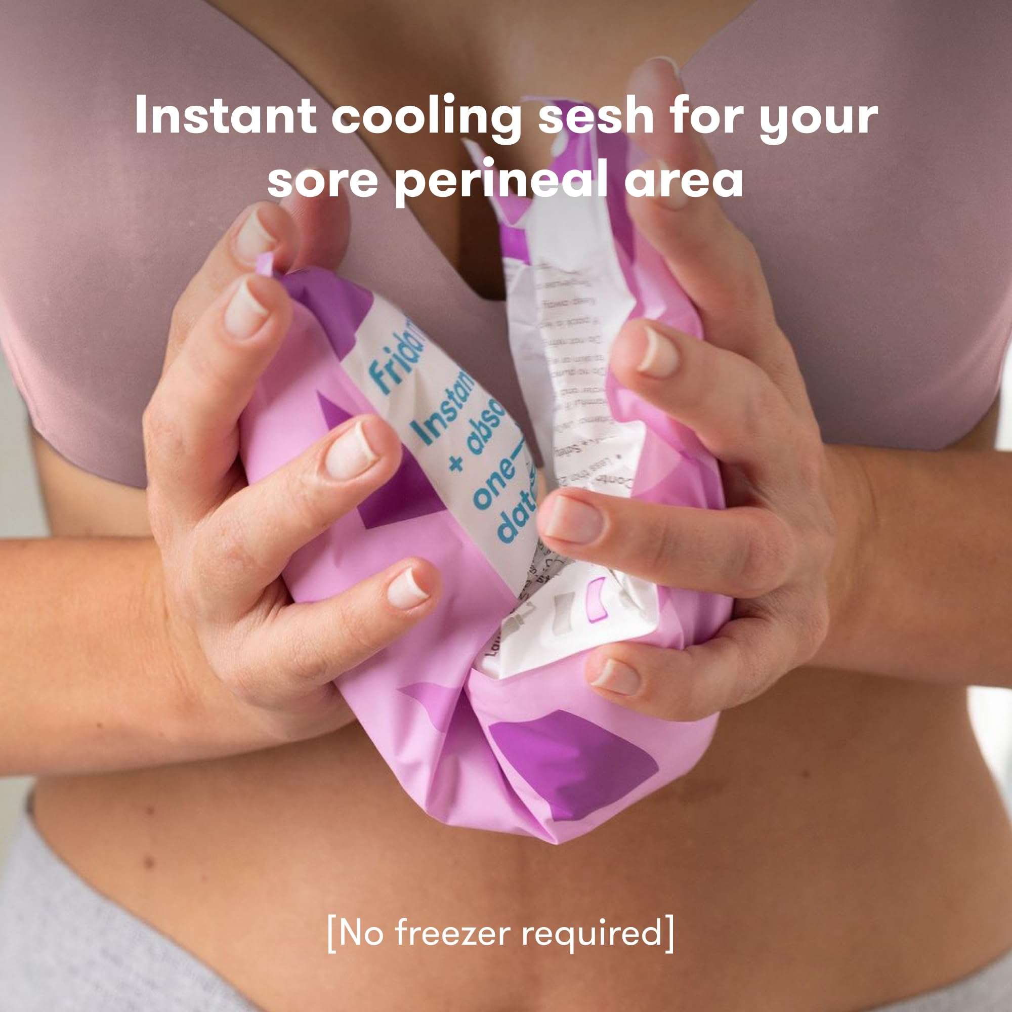 Frida Mom instant cooling pack held against lower abdomen showing purple single use pad postpartum ice pads for women