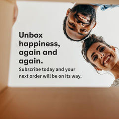 Smiling couple unboxing a subscription package promoting Garden of Life multivitamin for women and happy faces