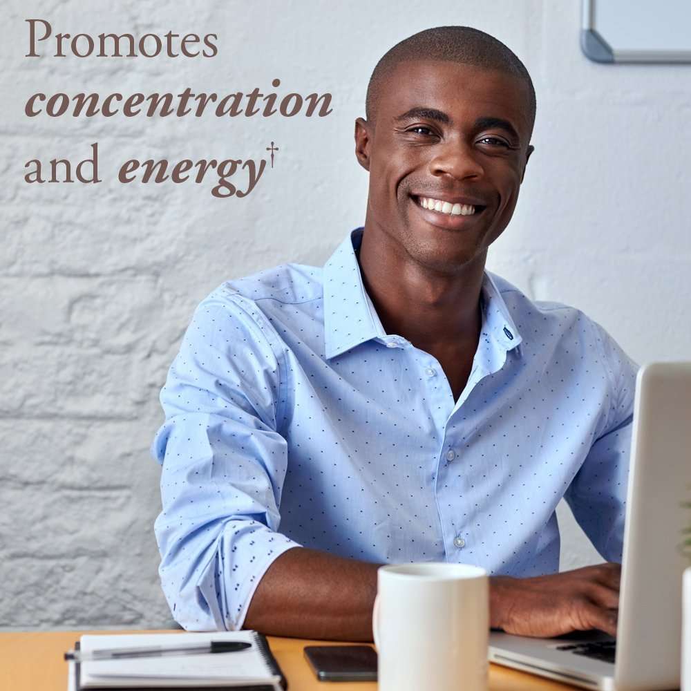 Garden of Life organic B12 spray UAE shown with smiling man at desk and laptop promoting concentration and energy