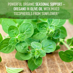 Garden of Life organic oil of oregano supplement label with fresh oregano sprigs on wood background