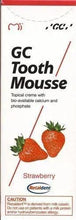 GC Tooth Mousse strawberry box front, white with bold GC Tooth Mousse text and strawberry art