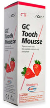 GC Tooth Mousse strawberry box, white with red strawberry graphics and red diagonal lines