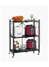 Black 3-tier kitchen organizer shelf with wheels holding cookware and pantry jars