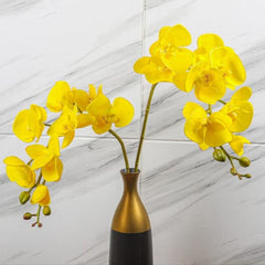 Huitich artificial yellow orchid flowers arranged in a modern gold and black vase on marble background