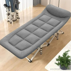 Huitich gray folding camping cot with cushioned surface and adjustable headrest on wooden floor