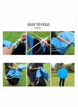 Pop-up camping tent with carry bag, poles, and stakes shown during setup