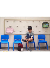 Lightweight playroom chair for kids by Huitich in bright blue with child sitting and backpacks hanging