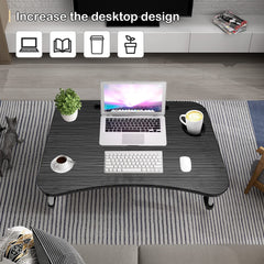 Portable laptop desk for bed with dark wood surface holding laptop keyboard mouse coffee and plant