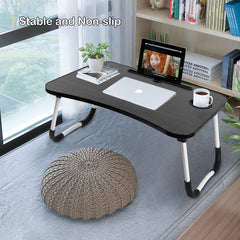 Portable laptop desk for bed with stable non-slip black surface holding laptop and tablet