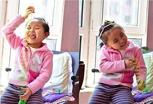 Child playing happily with Huitich rainbow magic spring toy in a cozy indoor setting
