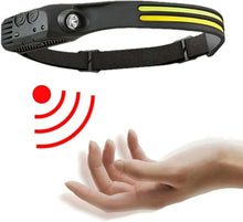 Rechargeable LED headlamp showing red wireless indicator next to hand