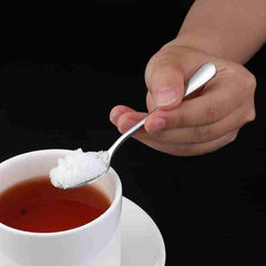Huitich stainless steel espresso spoons set measuring sugar into a cup of tea