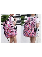 Geometric school backpack on wheels worn by child, pink and black patterned fabric