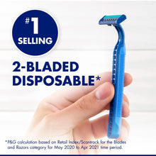 Disposable razor held in hand, blue handle and 2-blade head