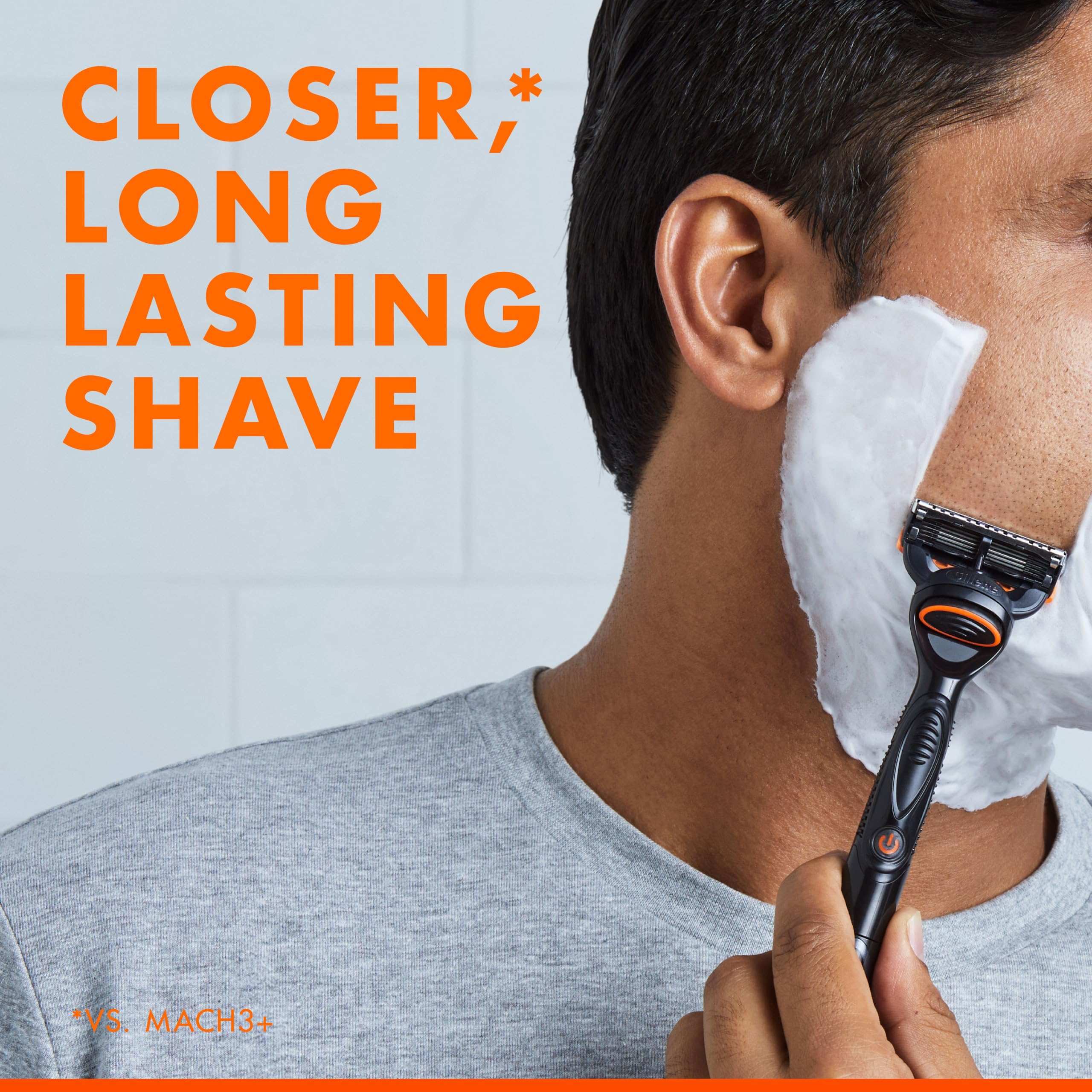 Close up of man shaving cheek with foam using Gillette Fusion Power blades 8 pack razor for a closer long lasting shave
