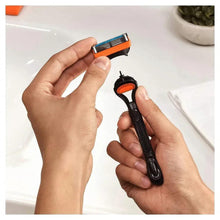 Fusion5 razor and blade cartridge held above a sink
