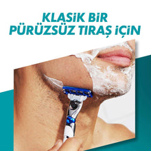 Men's razor cartridge shaving on skin with white foam, blue blade head.