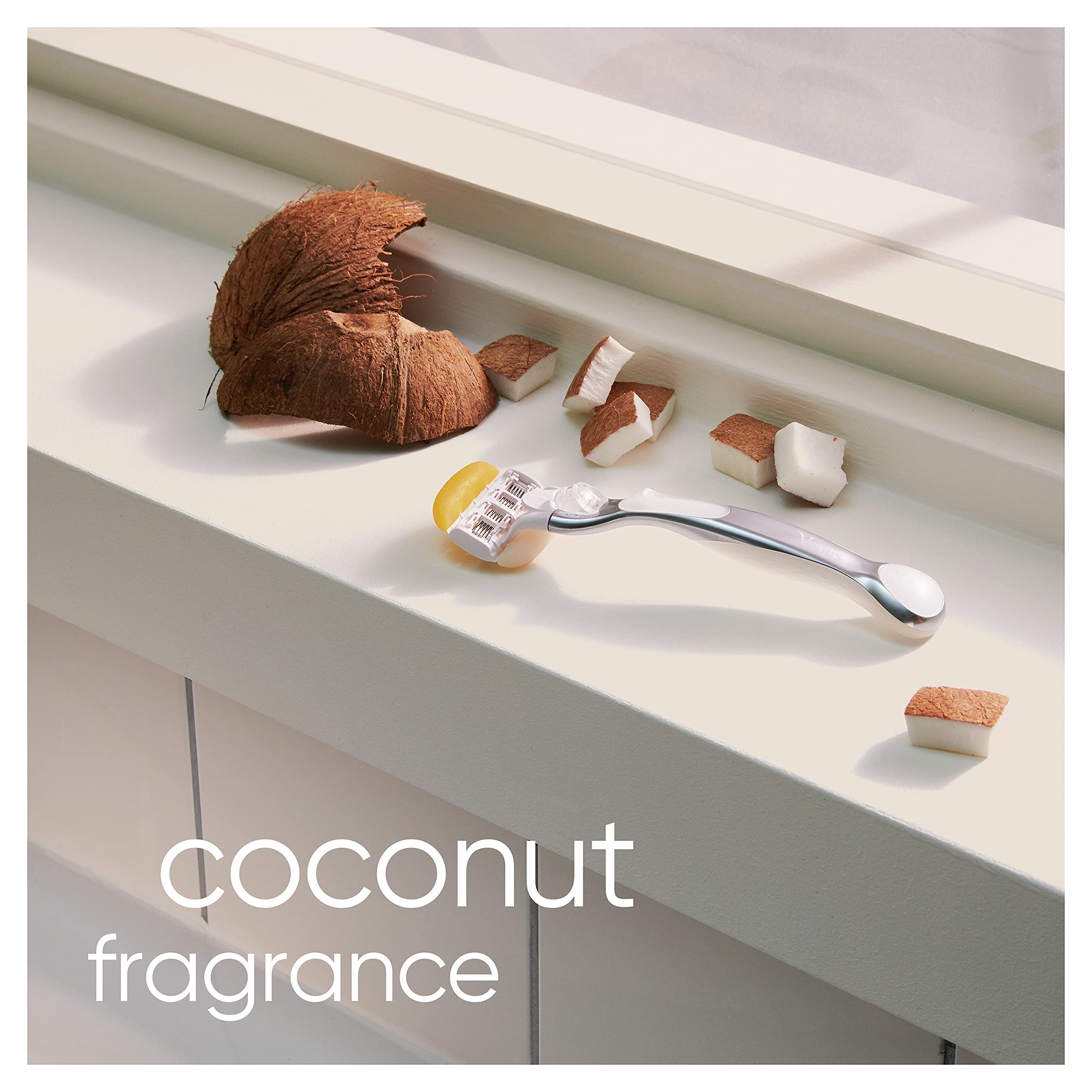 Gillette Venus and Olay razor refills coconut fragrance blade cartridge on silver handle beside coconut pieces on windowsill