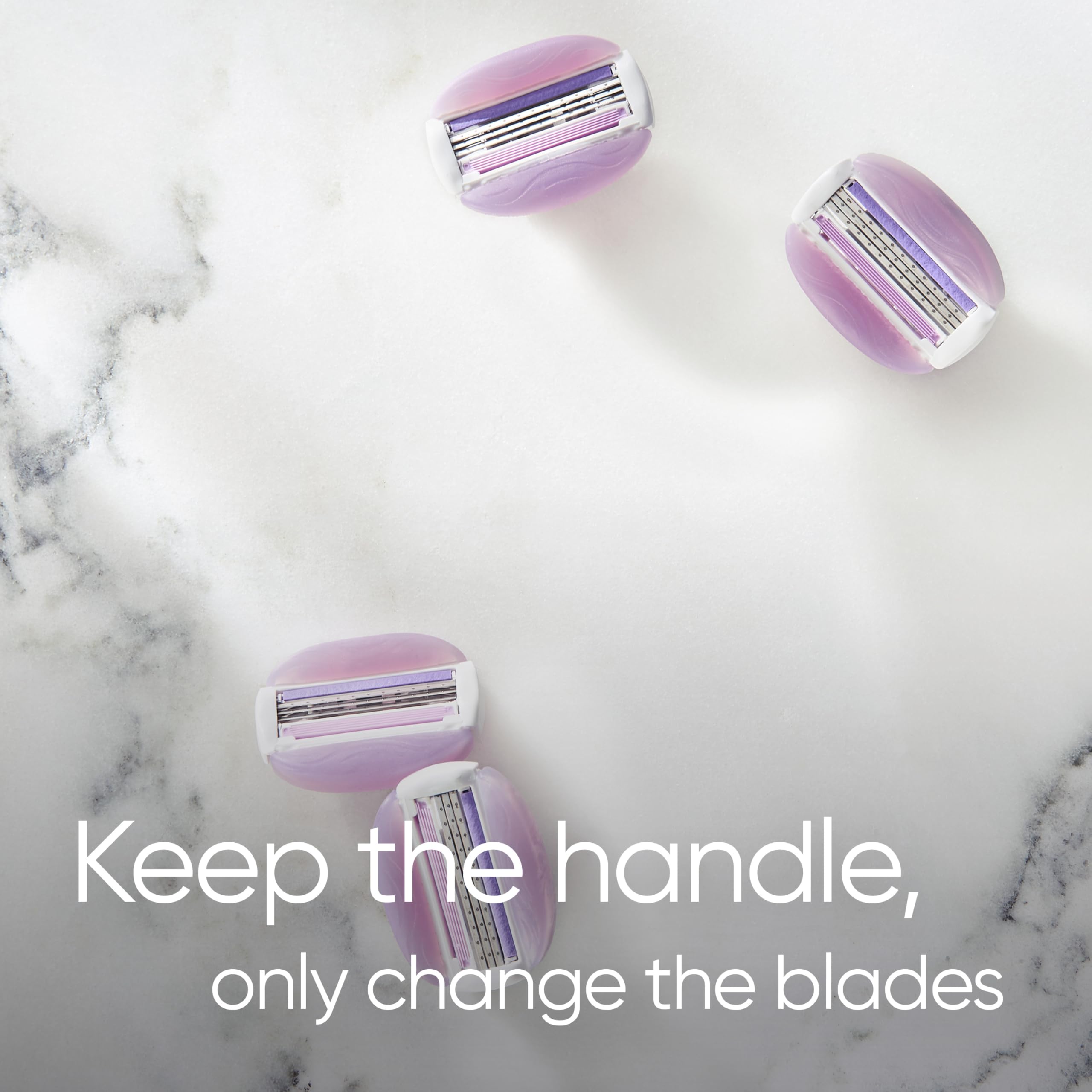 Four purple Gillette Venus razor blade refills for women on marble background with keep the handle text