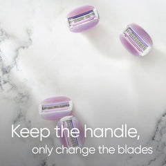 Four purple Gillette Venus razor blade refills for women on marble background with keep the handle text