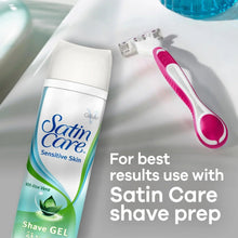 Disposable women’s razor with pink handle shown beside shave gel