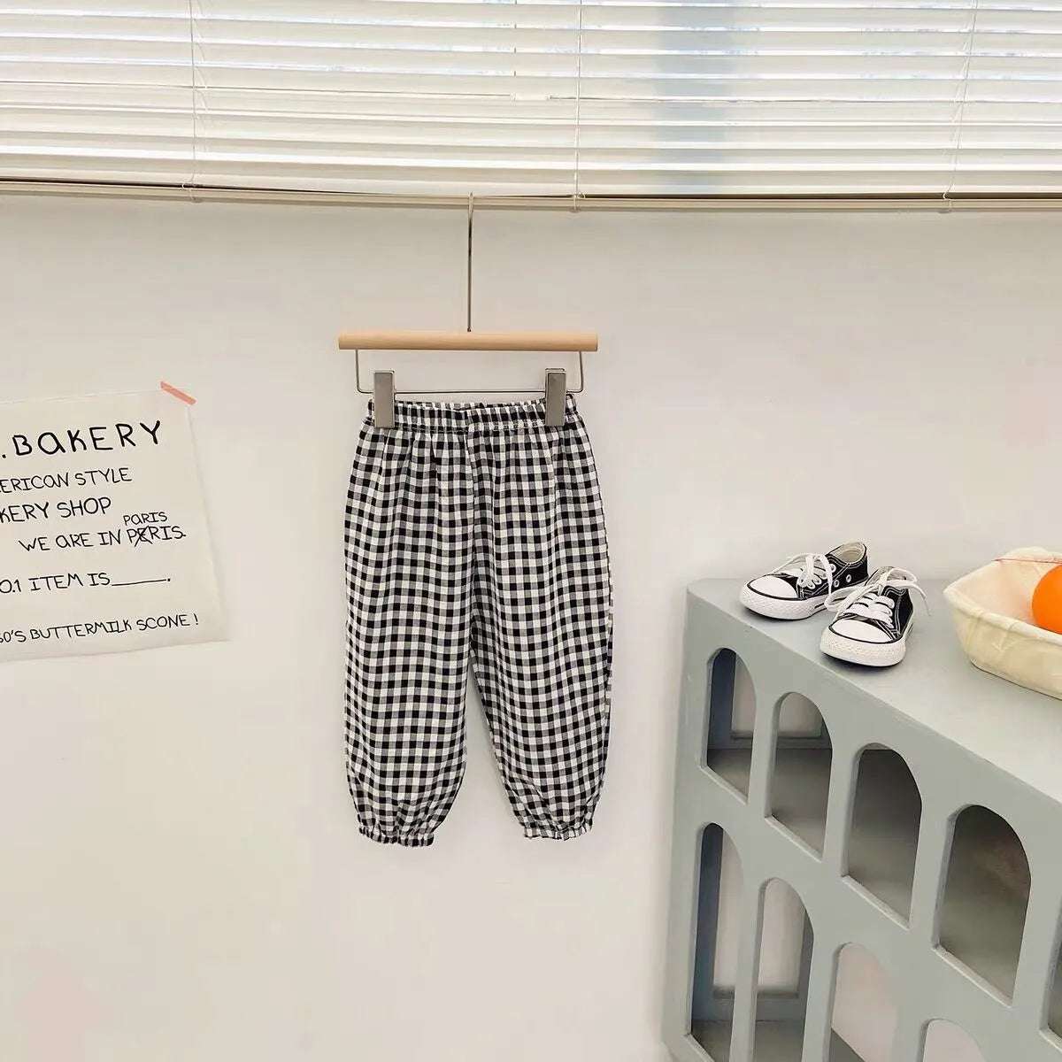 Mumzar girls plaid summer pants in black and white hanging on a wooden rack for stylish summer outfits
