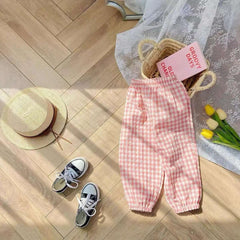 Mumzar girls plaid summer pants in pink, styled with sandals and a straw hat on a wooden floor