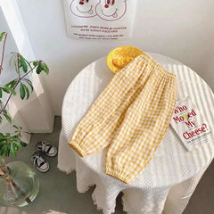 Mumzar girls plaid summer pants in yellow with an elastic waistband displayed on a table
