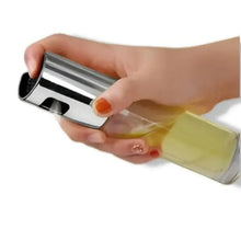 Olive oil spray bottle with clear glass body and stainless steel pump cap