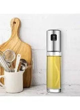 Clear glass olive oil spray bottle with stainless cap and built-in nozzle