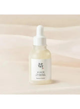 Skincare serum bottle with white dropper and light amber liquid