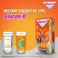 Box of glucon d orange glucose powder with poured orange drink glasses and fresh oranges