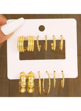 Gold-tone hoop earrings set with chunky and slim hoops on card, six pieces