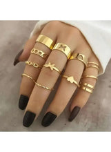 Gold adjustable ring set on hand with star and heart bands, stackable rings