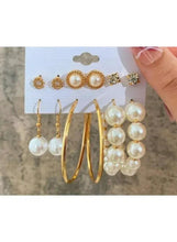 Gold-tone hoop and faux pearl drop earrings, shown on the card with studs