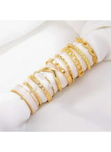 Gold-tone ring set with wide bands and white enamel stripe accents, stacked view