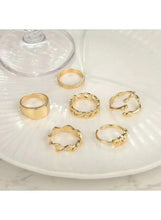 Gold tone chunky statement ring set with five geometric rings on a plate