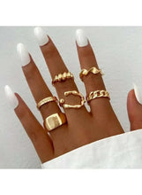 Gold tone chunky statement ring set on hand, five geometric band rings