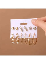 Gold-tone earrings set on card with pearl beads, small hoops, and crystal studs